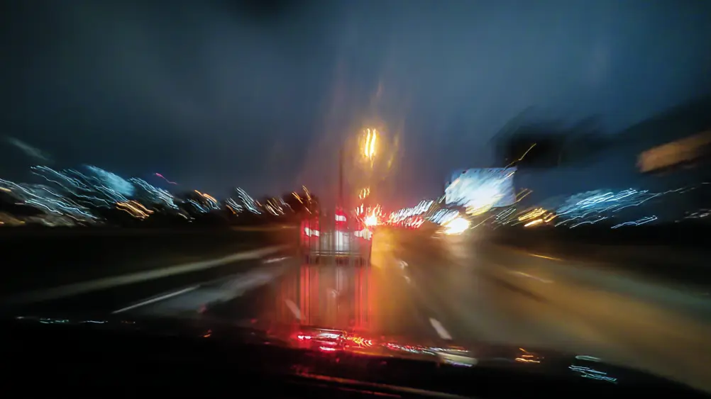 Car brake lights at night with visible PWM flicker pattern